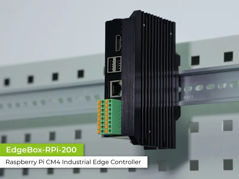 A sealed metal industrial controller with terminal blocks along one edge and antenna connectors.