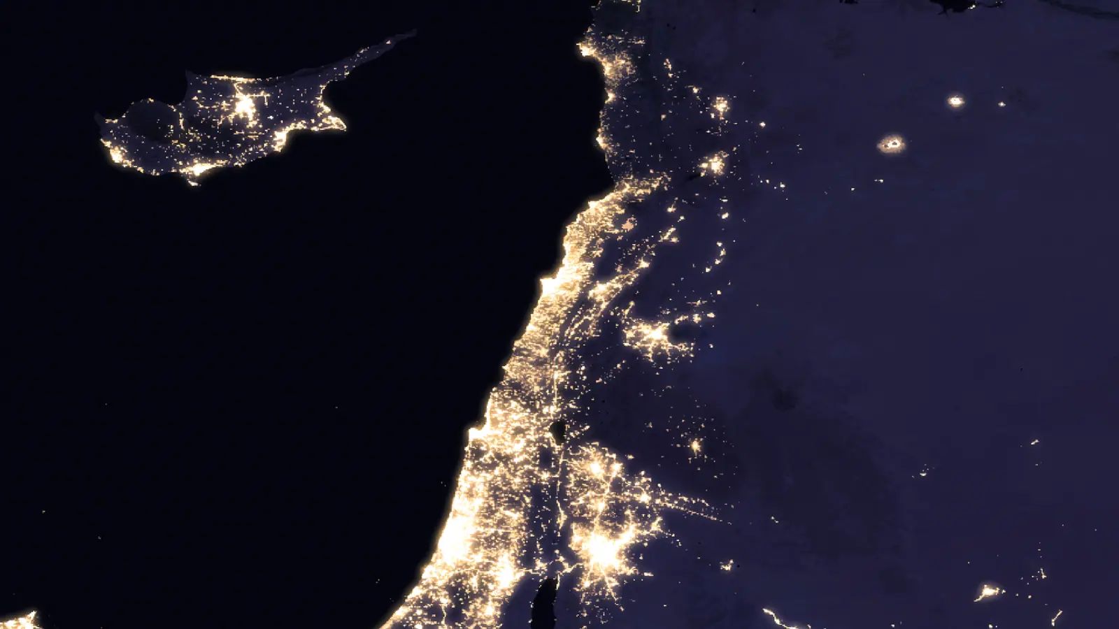 The eastern Mediterranean at night from orbit: Cyprus, and the lit ribbon of the Levantine coast against unlit interior.